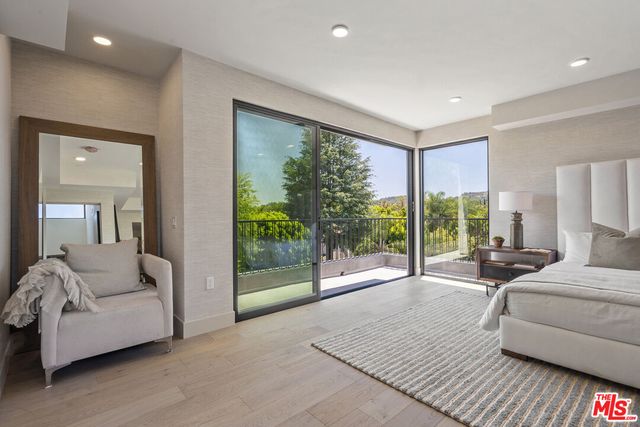a bedroom with a bed and large glass window