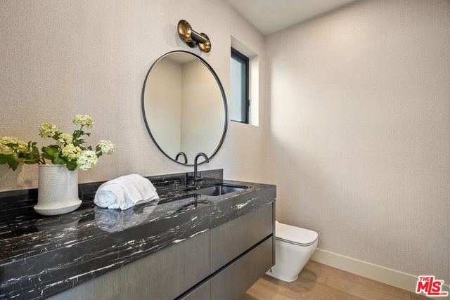 a kitchen with stainless steel appliances granite countertop a table chairs sink and cabinets