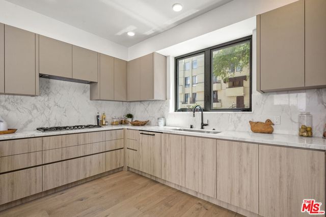 a kitchen with sink and cabinets