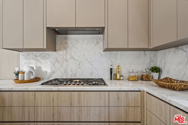 a kitchen with stainless steel appliances a sink stove and cabinets