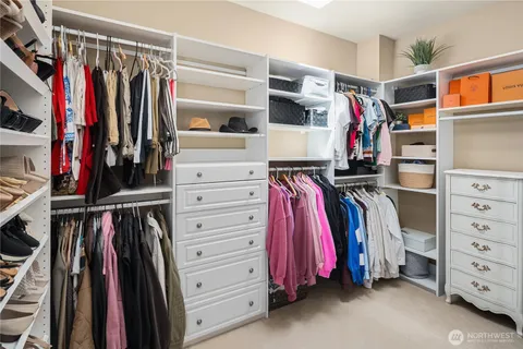 a view of walk in closet with clothes