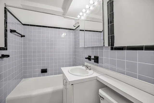 a bathroom with a sink a toilet and a bathtub