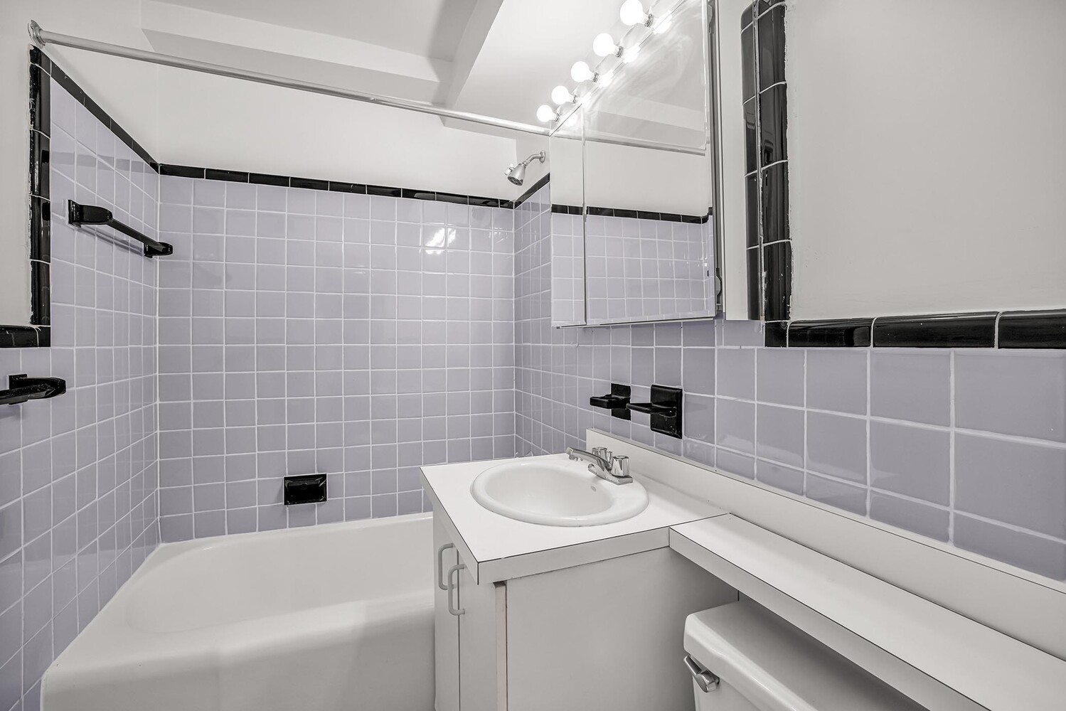 233 East 70th Street, Unit 10T Manhattan, NY 10021 - Photo 13 of 14 a bathroom with a sink a toilet and shower