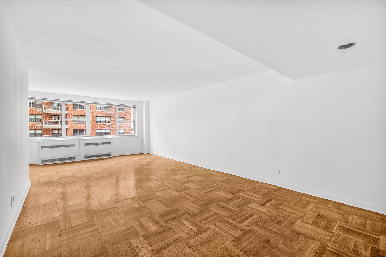 233 East 70th Street, Unit 10T Manhattan, NY 10021 - Photo 7 of 14 a view of an empty room with a window