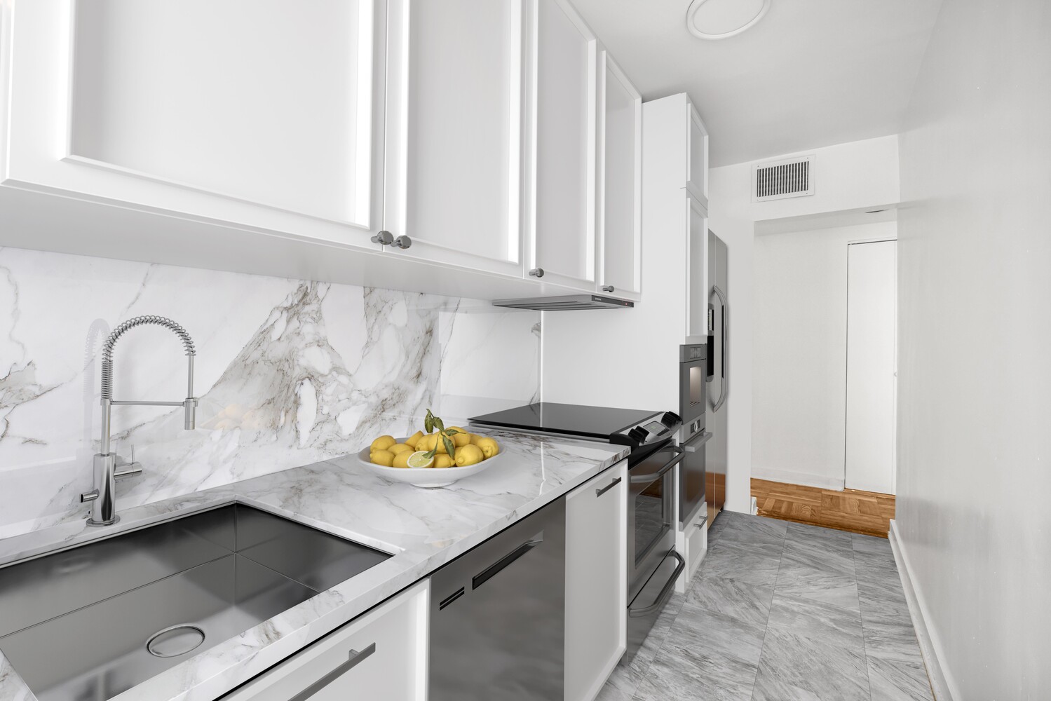 233 East 70th Street, Unit 10T Manhattan, NY 10021 - Photo 8 of 14 a kitchen with a sink and a stove top oven