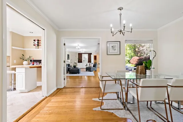 a view of a dining room with furniture and chandelier