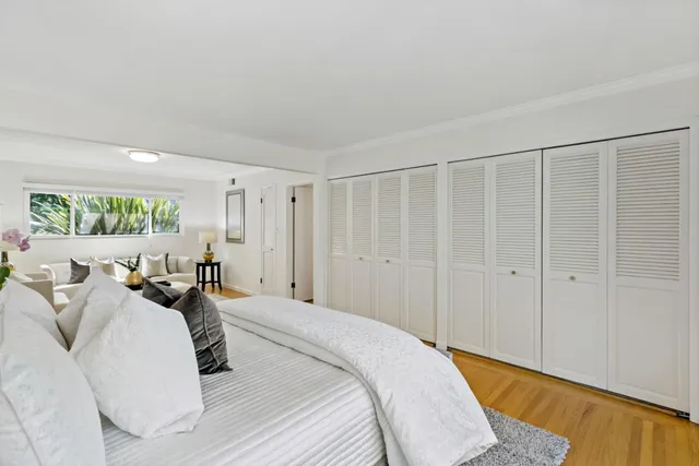 a large white bed in a white room