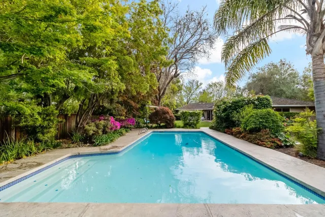 a view of a swimming pool with an outdoor seating