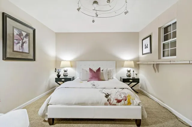 a bedroom with a bed and window