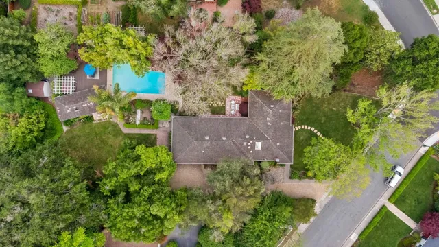 an aerial view of a house with garden space and street view