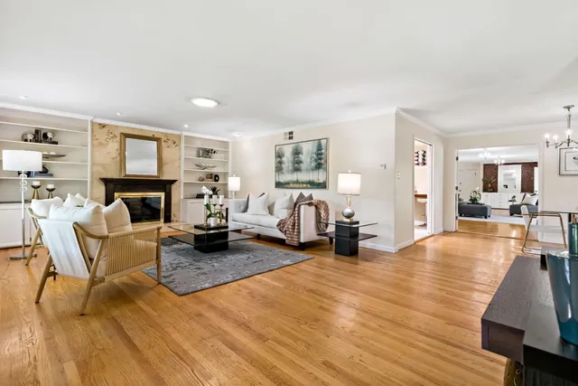 a living room with fireplace furniture and a wooden floor