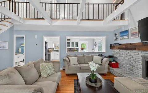 a living room with furniture kitchen view and a fireplace