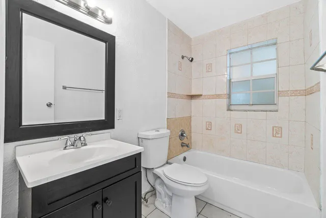 a bathroom with a sink toilet a mirror and shower