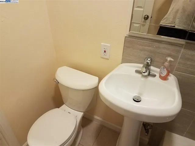 a white toilet sitting next to a bathroom sink