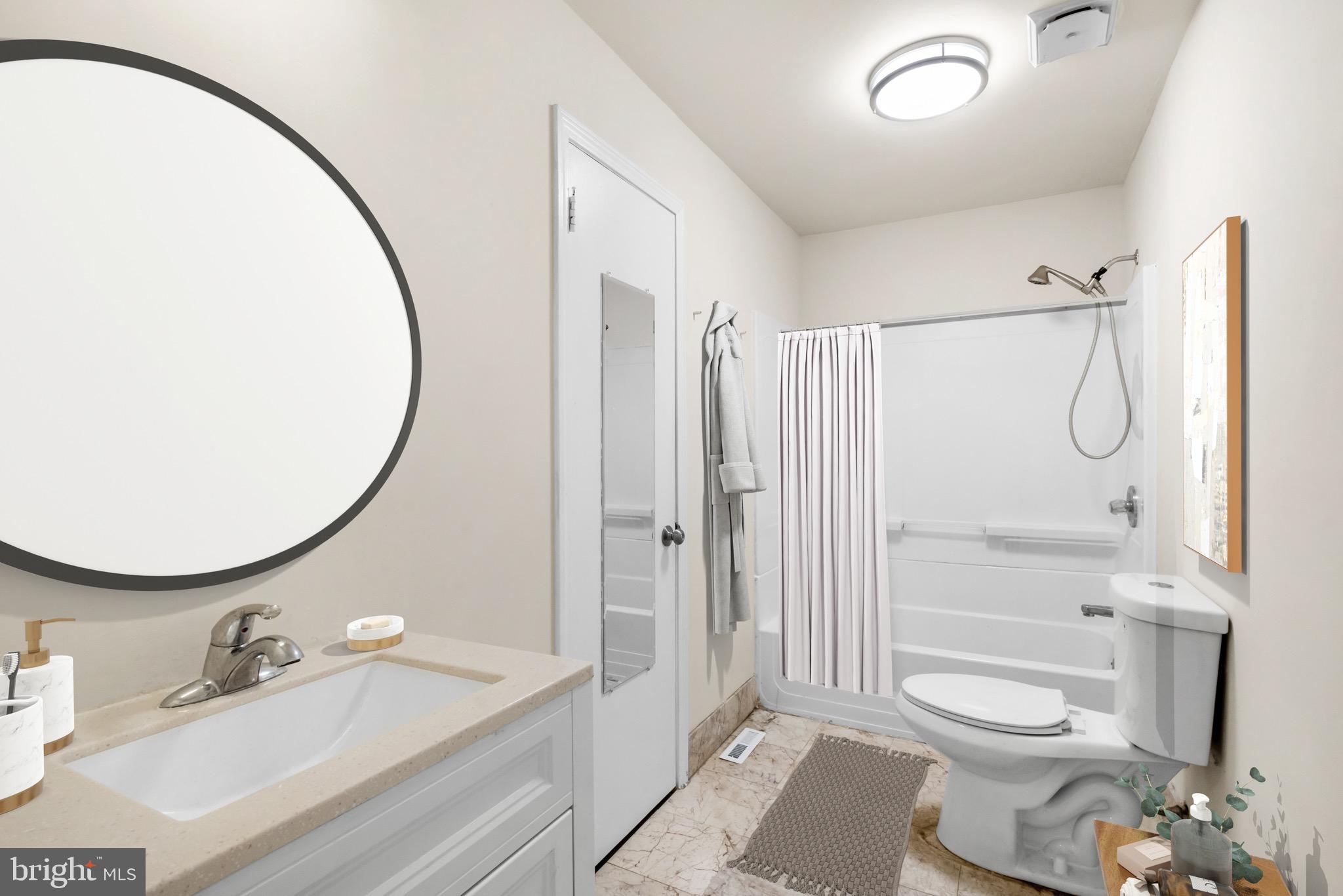 234 Bainbridge Street, Unit 2F Philadelphia, PA 19147 - Photo 5 of 10 a bathroom with a granite countertop sink toilet a mirror and shower