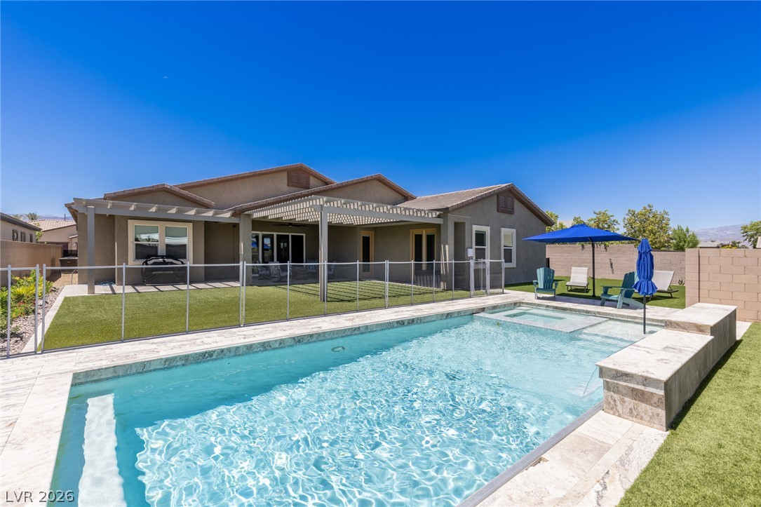 7036 Arabian Ridge Street Las Vegas, NV 89131 - Photo 48 of 64 Sparkling pool and spa with an automated cover, cantilever umbrella, and safety fence perfect for escaping those hot summer days.