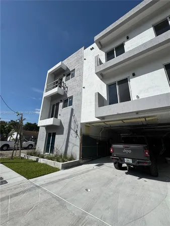 a view of building with car parked