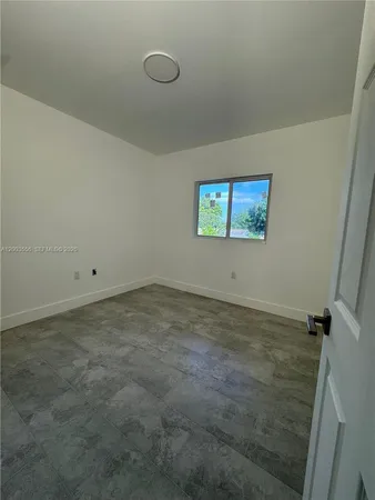 a view of empty room with windows