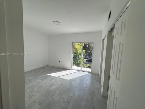 a view of an empty room with a window