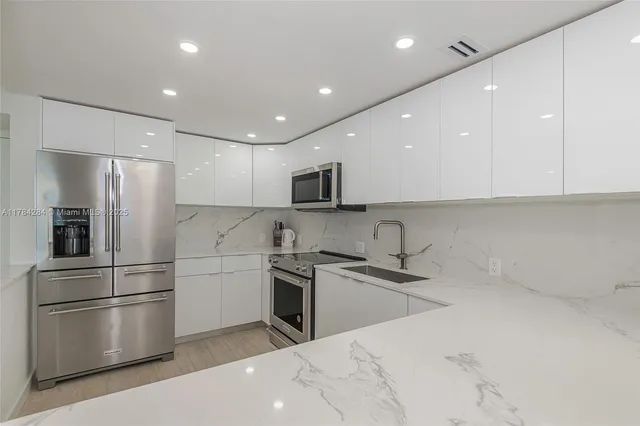 a kitchen with stainless steel appliances a refrigerator and a sink
