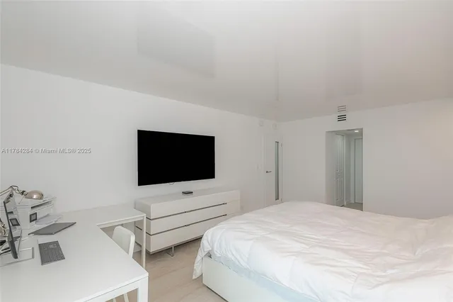 a large white bed in a white room