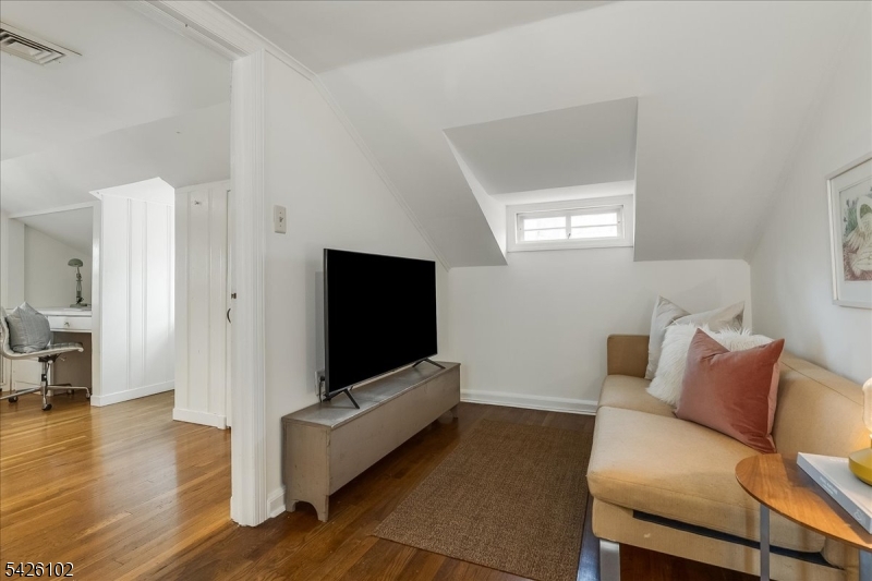 8 Lessing Road West Orange, NJ 07052 - Photo 25 of 40 a living room with furniture and a flat screen tv