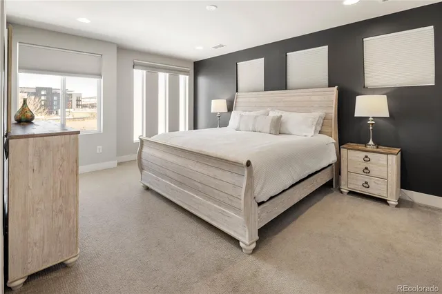 a spacious bedroom with a bed and cabinets