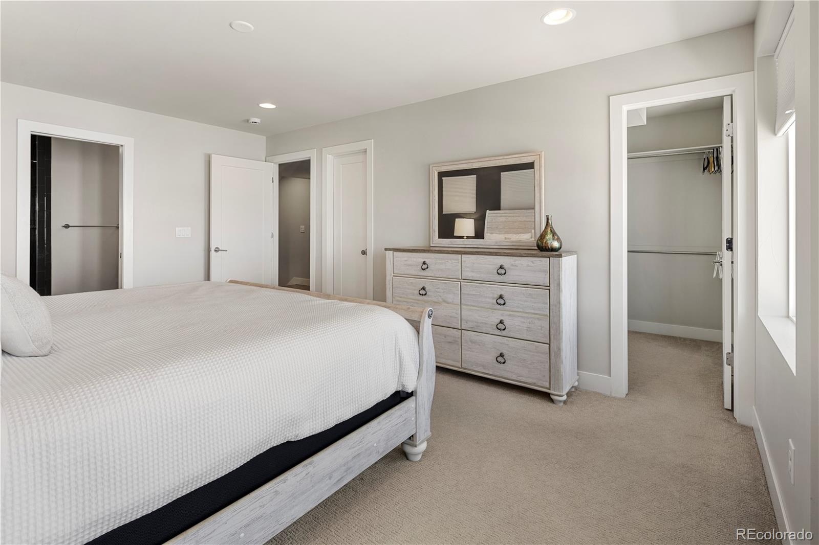 1815 Grove Street Denver, CO 80204 - Photo 16 of 36 a spacious bedroom with a bed and cabinets