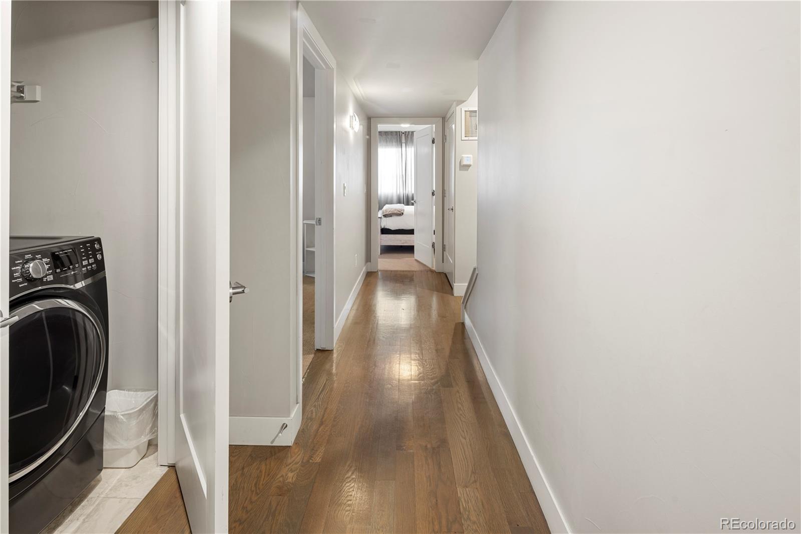 1815 Grove Street Denver, CO 80204 - Photo 19 of 36 a view of a hallway with wooden floor