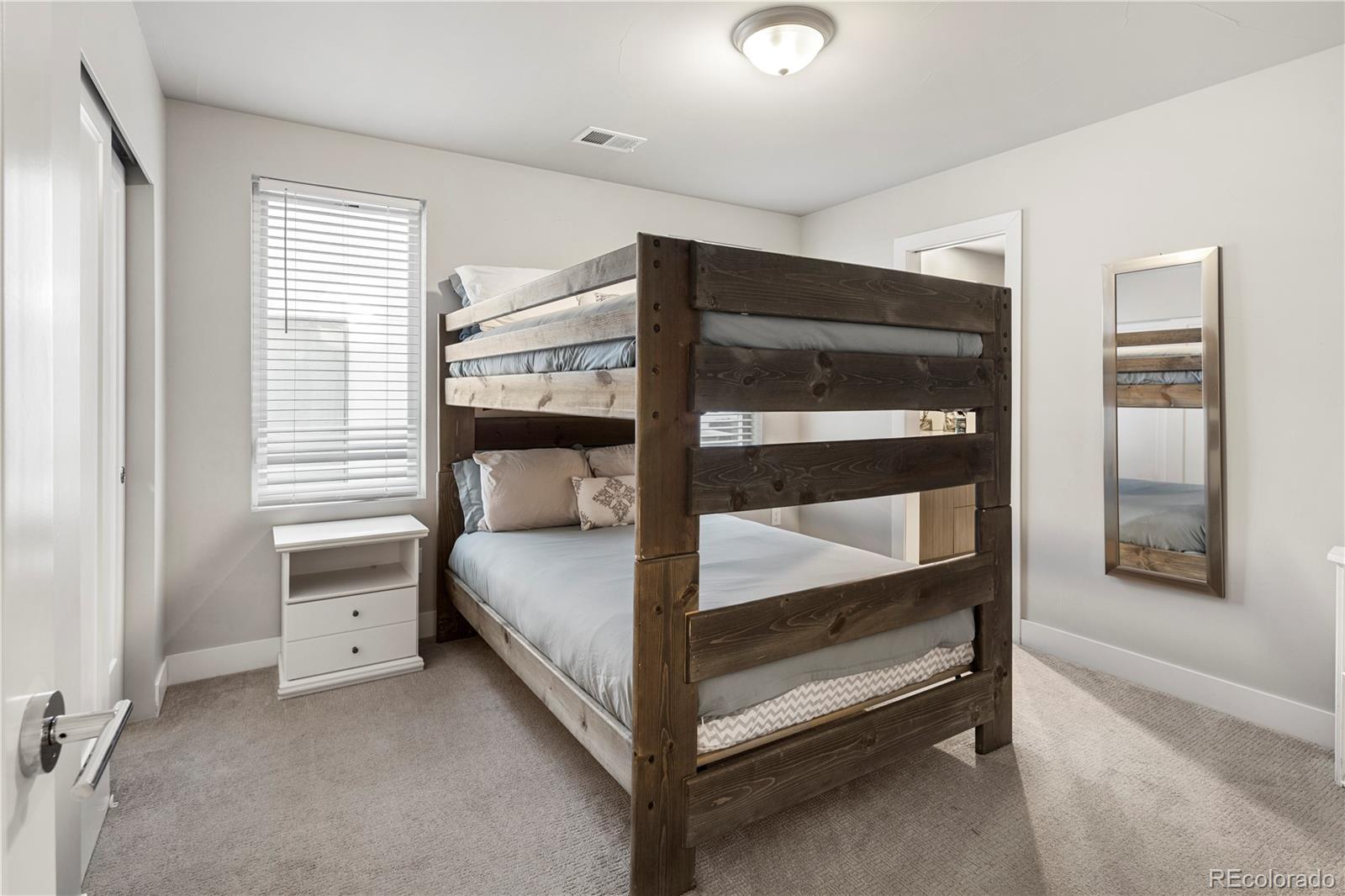 1815 Grove Street Denver, CO 80204 - Photo 20 of 36 a bedroom with a bed and a window