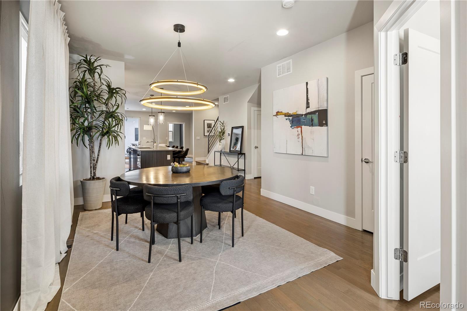 1815 Grove Street Denver, CO 80204 - Photo 3 of 36 a view of a dining room with a table and chairs