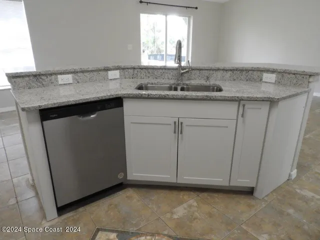 a kitchen with a sink and a mirror