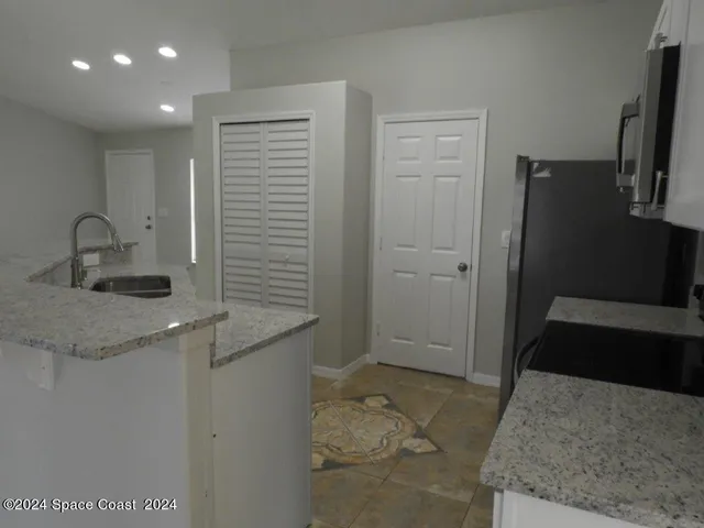 a kitchen with a sink and refrigerator