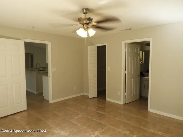 a view of a chandelier fan and a livingroom with a chandelier fan