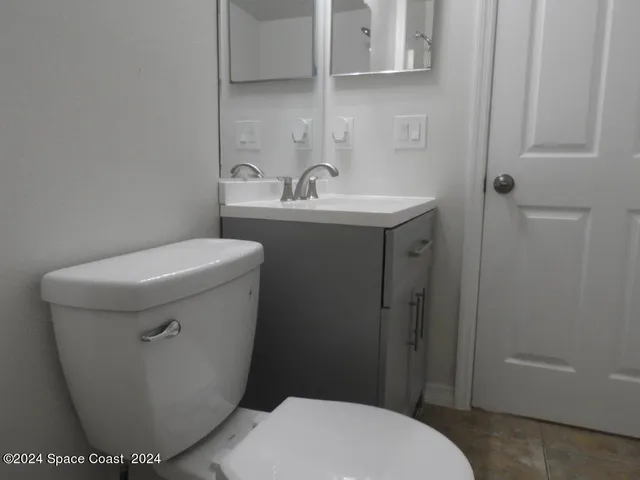 a white toilet sitting next to a bathroom sink