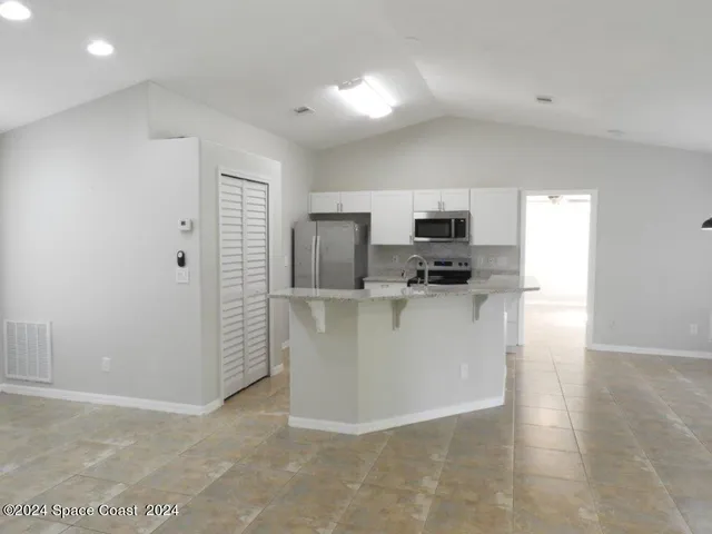 a view of a kitchen with microwave and cabinets