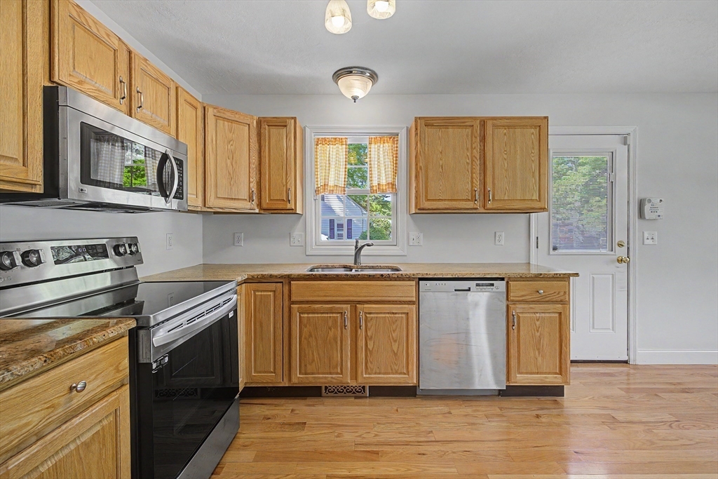 792 Ryan Road Northampton, MA 01062 - Photo 6 of 29 a kitchen with stainless steel appliances granite countertop a stove a sink and a microwave