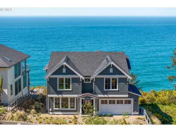 a aerial view of house with an ocean view