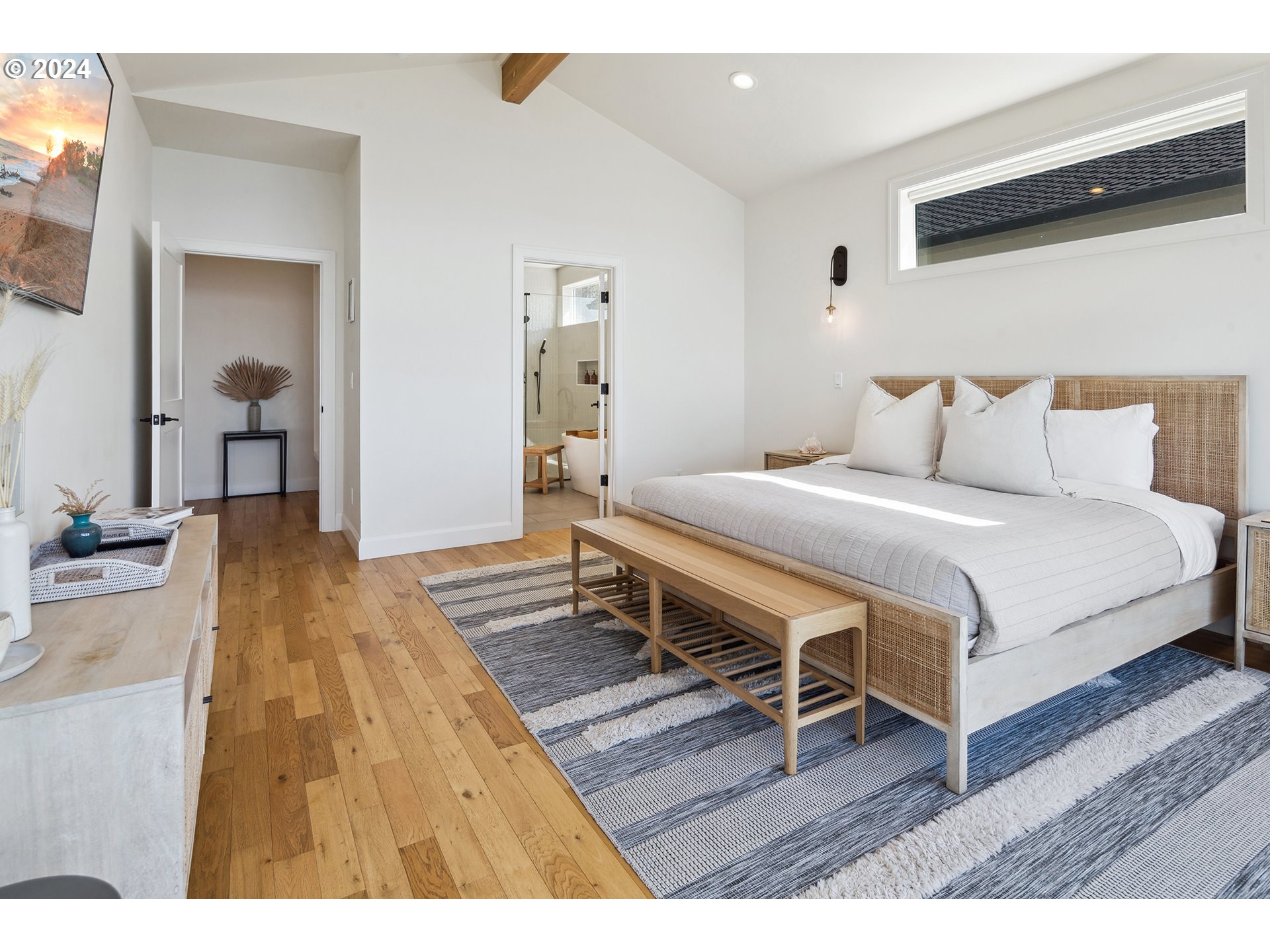 54150 South Beach Road Neskowin, OR 97149 - Photo 25 of 48 a bedroom with a bed and wooden floor