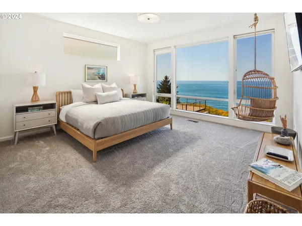 a bedroom with a bed and a flat tv screen on dresser