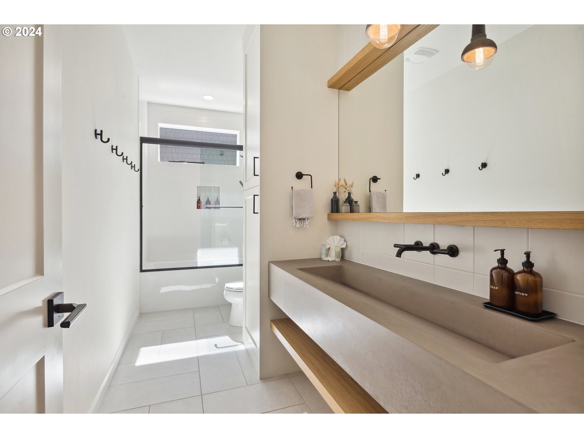 54150 South Beach Road Neskowin, OR 97149 - Photo 32 of 48 a en suite bathroom with a granite countertop sink and a mirror