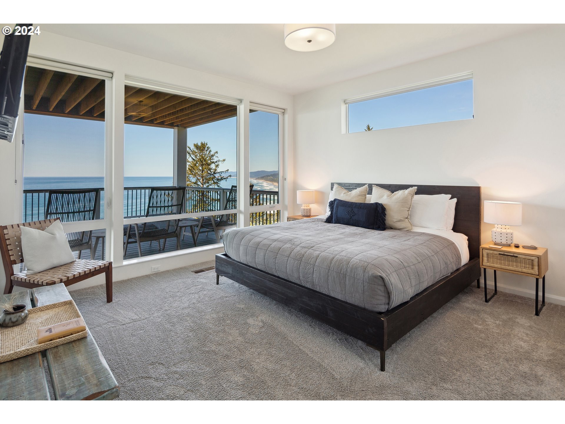 54150 South Beach Road Neskowin, OR 97149 - Photo 33 of 48 a bedroom with a large bed and a large window