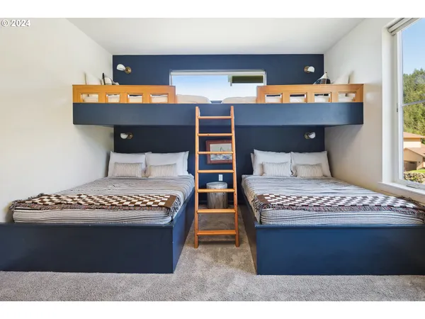 a bedroom with a bed painting and window