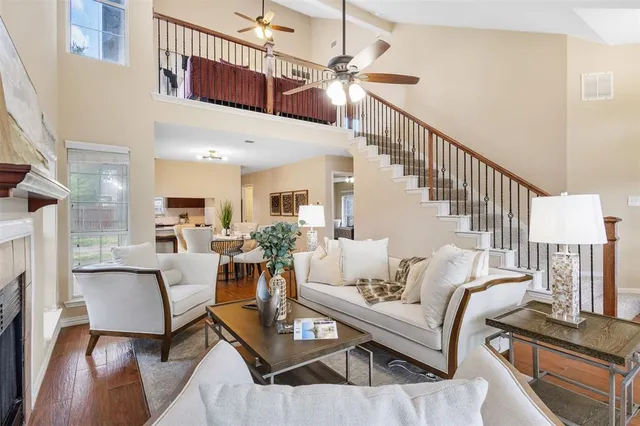 a living room with furniture kitchen view and a chandelier