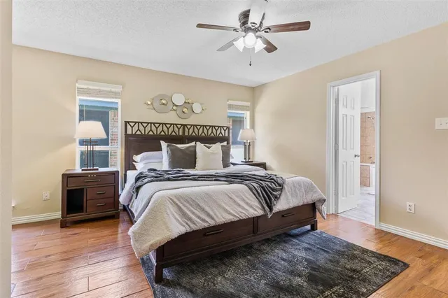 a bedroom with bed and wooden floor