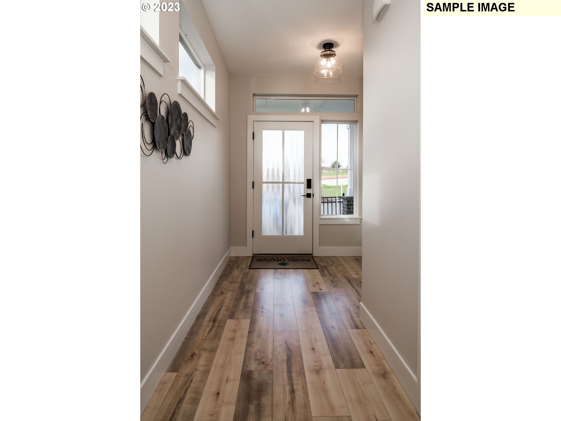 1009 South 46th Place Ridgefield, WA 98642 - Photo 4 of 12 a view of a room with wooden floor and a window