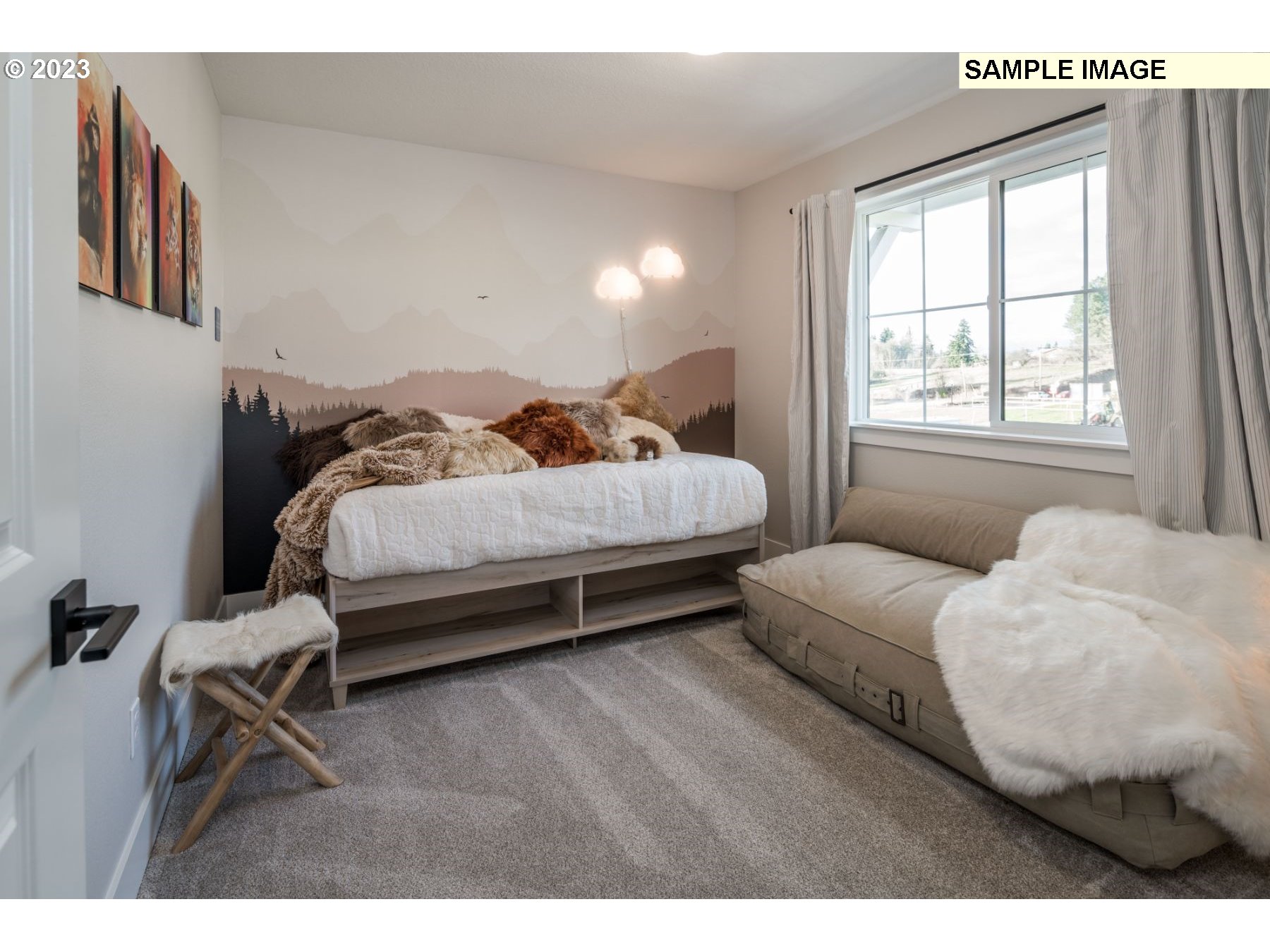 1009 South 46th Place Ridgefield, WA 98642 - Photo 8 of 12 a bedroom with a bed and a large window