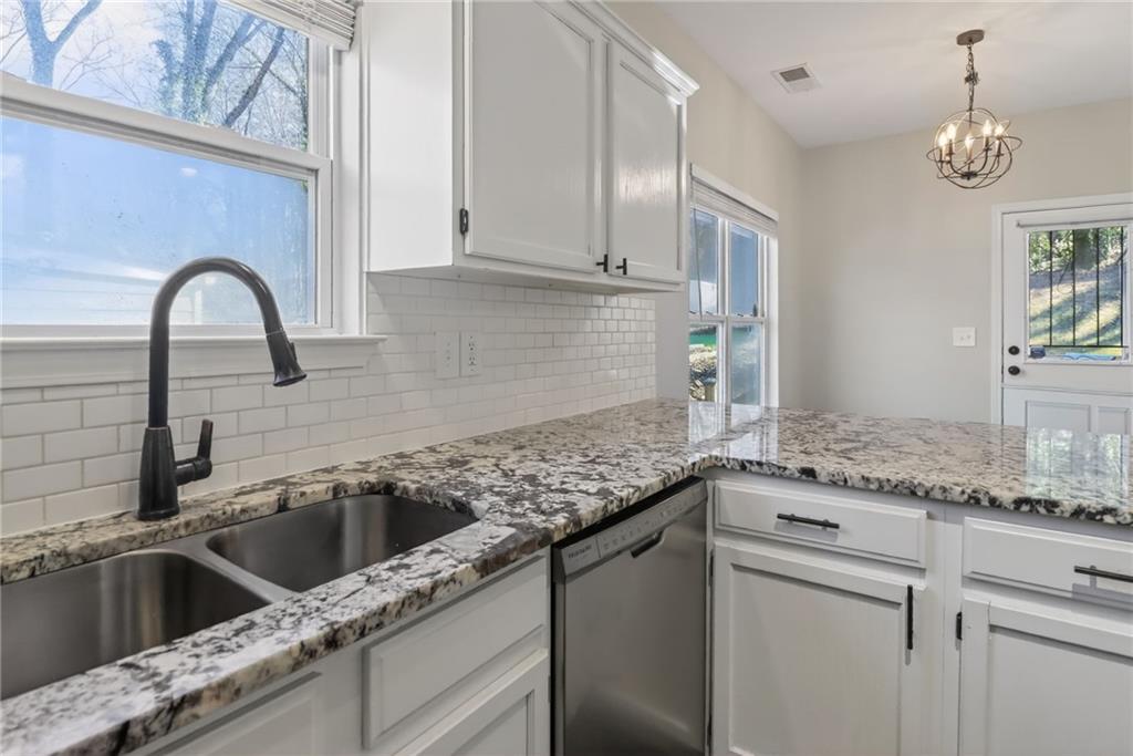 991 Ada Avenue Northwest Atlanta, GA 30318 - Photo 12 of 32 a kitchen with granite countertop a sink stainless steel appliances and cabinets