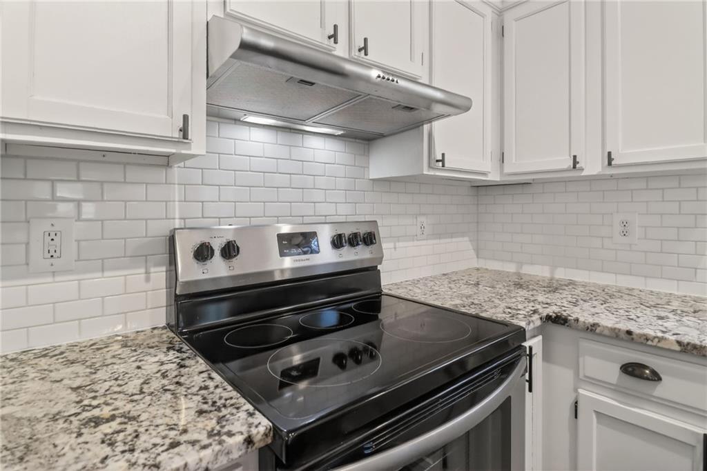 991 Ada Avenue Northwest Atlanta, GA 30318 - Photo 13 of 32 a stove top oven sitting inside of a kitchen