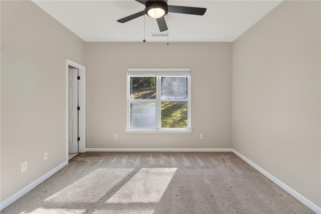 991 Ada Avenue Northwest Atlanta, GA 30318 - Photo 18 of 32 an empty room with windows and ceiling fan